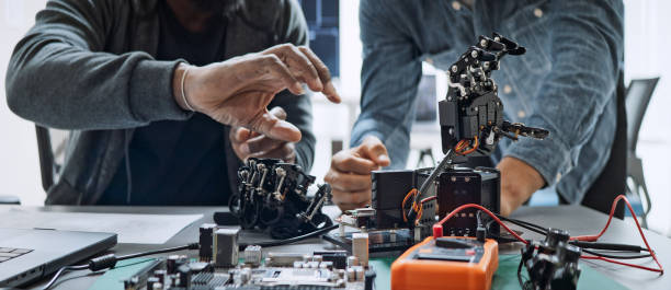 Engineers working with robotic hardware in a testing environment